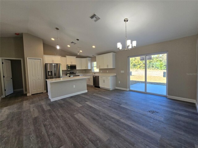 kitchen with visible vents, a center island, light countertops, stainless steel appliances, and dark wood-style flooring