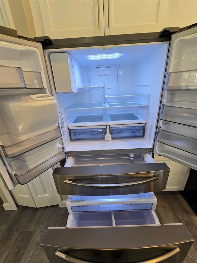 details featuring refrigerator and dark wood-style flooring