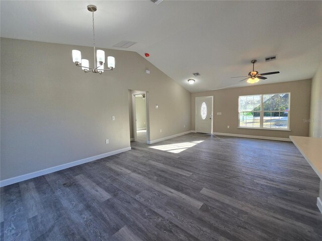 unfurnished living room with baseboards, dark wood-type flooring, ceiling fan with notable chandelier, and vaulted ceiling