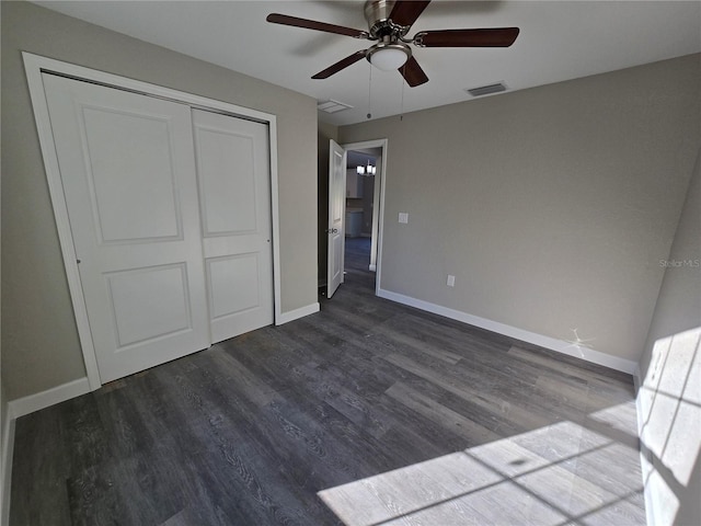 unfurnished bedroom featuring dark wood-type flooring, baseboards, and visible vents