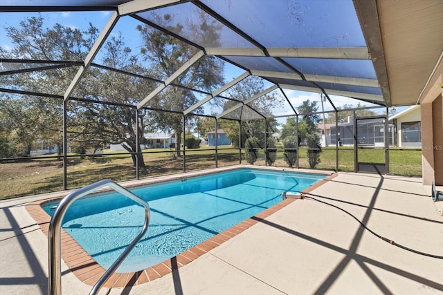 pool with glass enclosure and a patio area