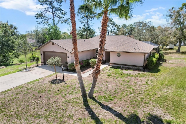 view of front of house with a shingled roof, a front lawn, concrete driveway, stucco siding, and a garage