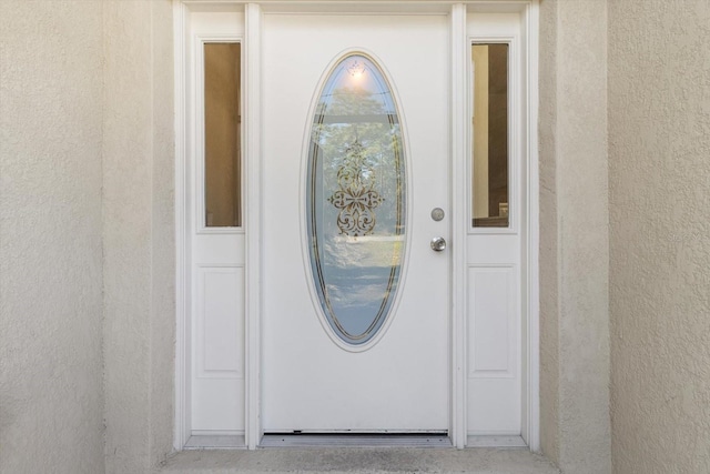 property entrance featuring stucco siding