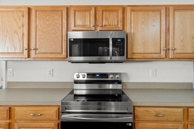 kitchen featuring appliances with stainless steel finishes and light countertops