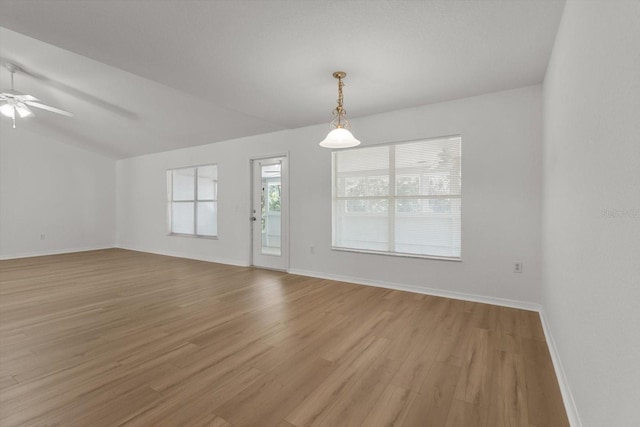 spare room with light wood-style flooring, a ceiling fan, and baseboards