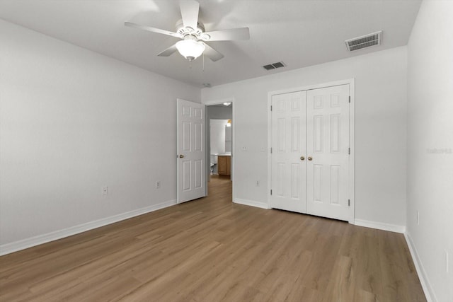 unfurnished bedroom with baseboards, visible vents, and light wood finished floors