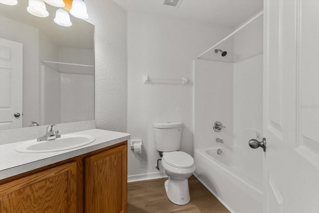 full bath with visible vents, toilet, wood finished floors, shower / bathing tub combination, and vanity