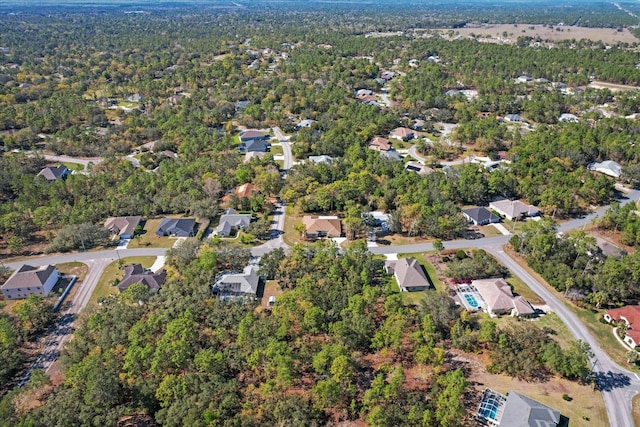 bird's eye view featuring a residential view and a view of trees