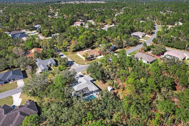 birds eye view of property with a residential view and a wooded view