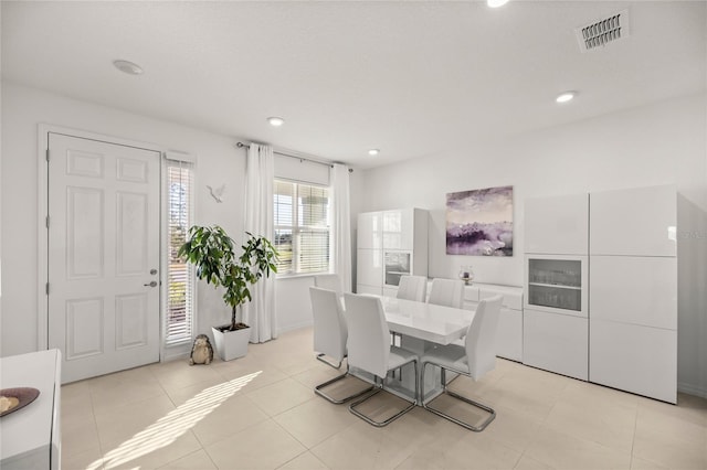 dining area with light tile patterned floors, visible vents, and recessed lighting