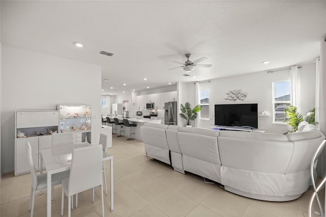 living area with plenty of natural light, recessed lighting, visible vents, and ceiling fan