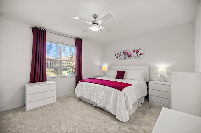 carpeted bedroom featuring baseboards and a ceiling fan