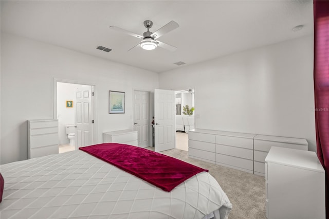 bedroom with visible vents, carpet floors, ceiling fan, and ensuite bathroom