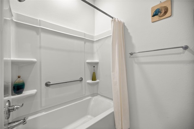 bathroom with shower / bath combination with curtain