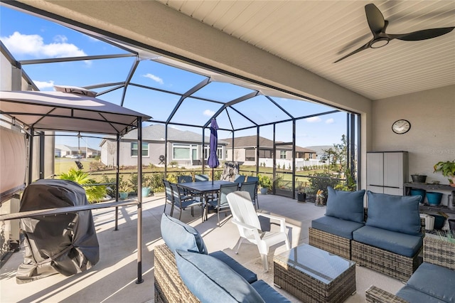 view of patio featuring area for grilling, ceiling fan, outdoor lounge area, outdoor dining area, and a lanai