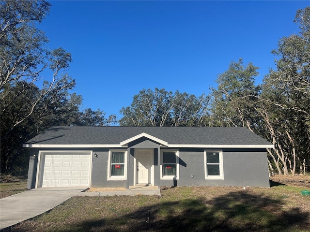 ranch-style home featuring stucco siding, concrete driveway, an attached garage, and a shingled roof