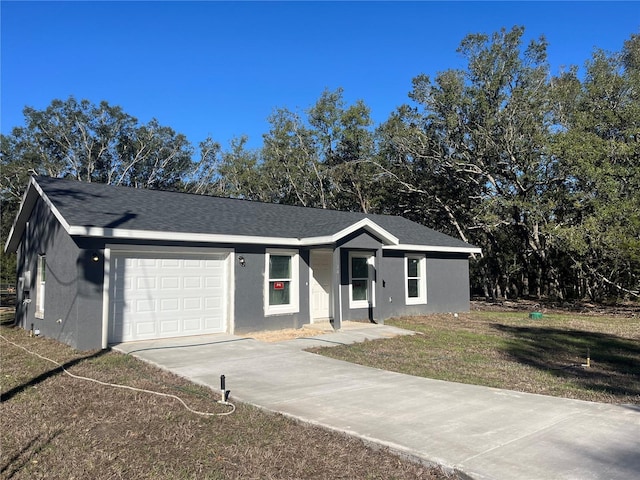 ranch-style home with stucco siding, driveway, an attached garage, and a shingled roof