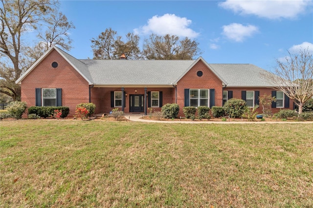 single story home with brick siding and a front yard