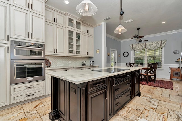 kitchen featuring ornamental molding, decorative light fixtures, stone tile flooring, double oven, and black electric cooktop