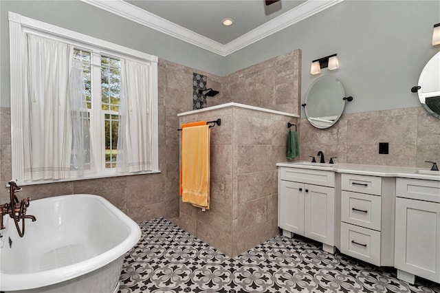 full bath with ornamental molding, a walk in shower, a sink, tile walls, and a freestanding bath