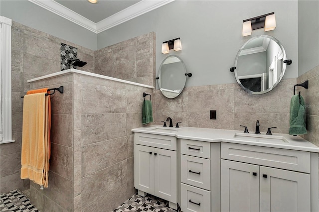 full bathroom with tile walls, crown molding, walk in shower, and a sink