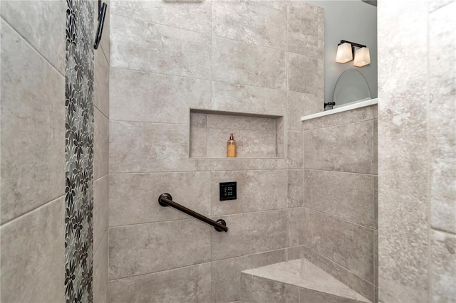 interior details featuring tiled shower