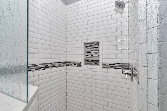 bathroom with a tile shower