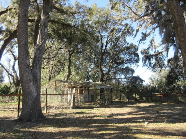 view of yard with an outbuilding, exterior structure, and fence