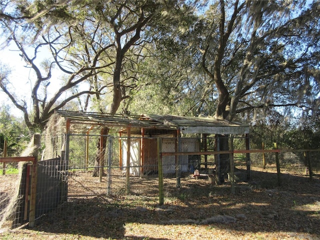 view of poultry coop featuring fence