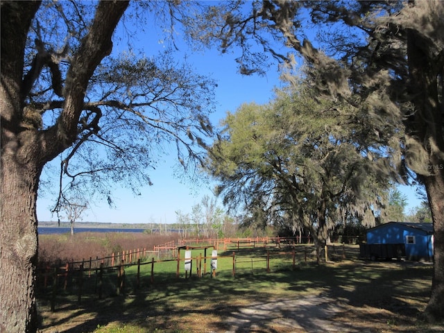 view of yard featuring a rural view and fence