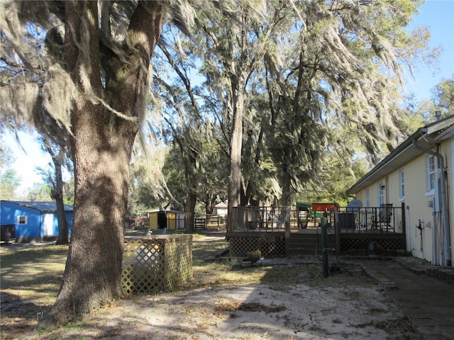 view of yard featuring a wooden deck