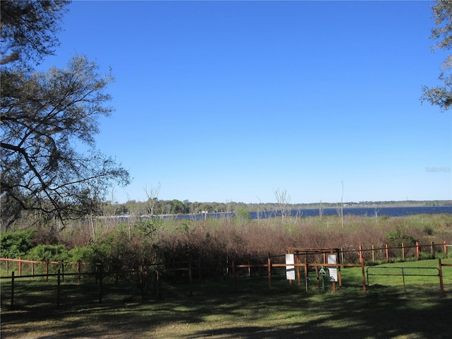 view of yard featuring a rural view and fence