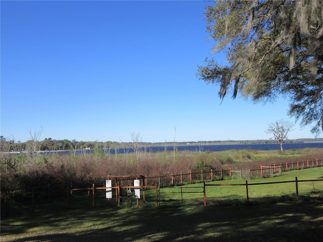 view of yard featuring a rural view and fence