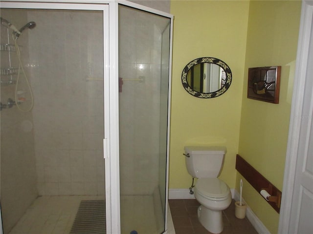 full bath with tile patterned floors, toilet, baseboards, and a stall shower