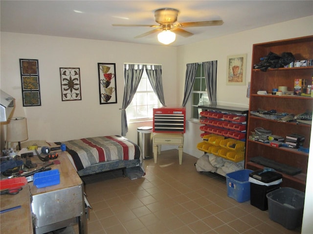 tiled bedroom with a ceiling fan