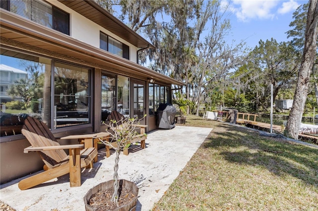 view of yard featuring a sunroom and a patio area