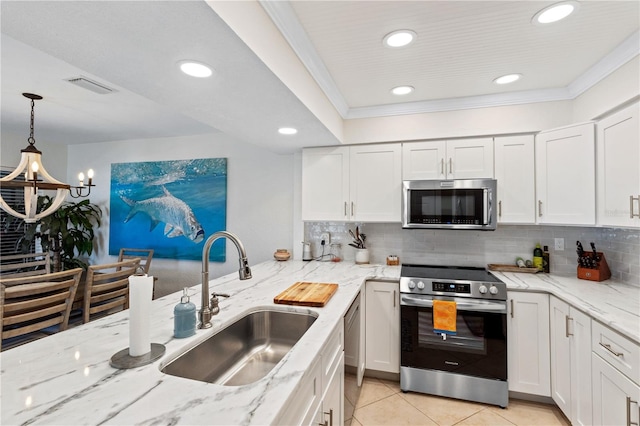 kitchen featuring decorative backsplash, visible vents, appliances with stainless steel finishes, and a sink