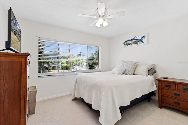 bedroom with baseboards, light carpet, and a ceiling fan