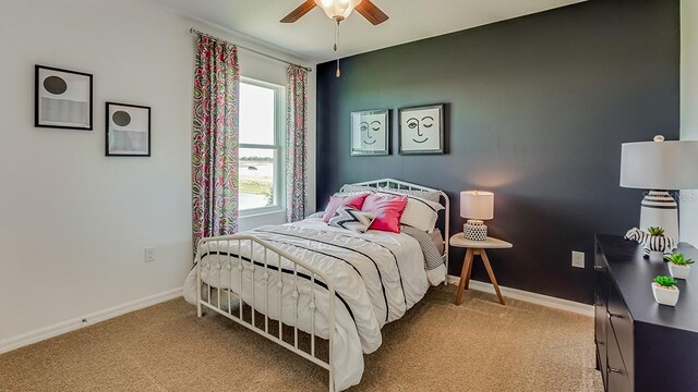 bedroom with carpet flooring, a ceiling fan, and baseboards