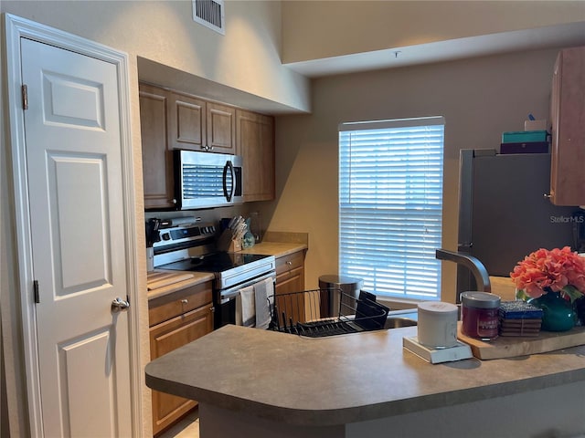 kitchen featuring visible vents and stainless steel appliances