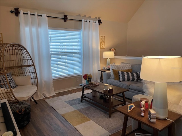 living room with baseboards, lofted ceiling, and wood finished floors