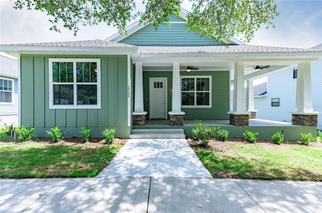 view of front of home featuring a porch, board and batten siding, a ceiling fan, and roof with shingles