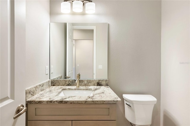 bathroom with toilet and vanity