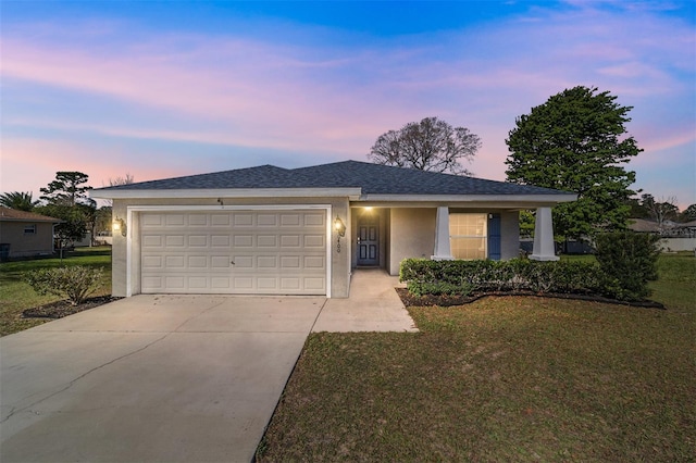 single story home featuring roof with shingles, stucco siding, concrete driveway, a front lawn, and a garage