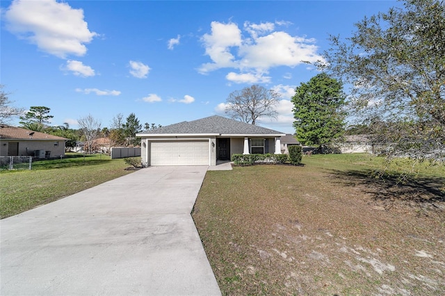 ranch-style house with fence, stucco siding, a front lawn, concrete driveway, and a garage