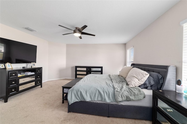 bedroom with visible vents, a ceiling fan, baseboards, and carpet floors