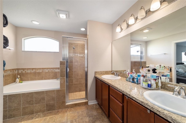 full bathroom with plenty of natural light, a stall shower, and a sink