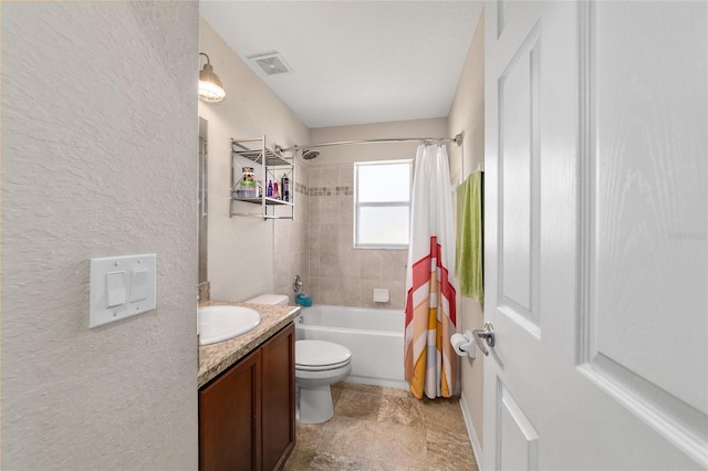 bathroom featuring visible vents, toilet, shower / tub combo with curtain, vanity, and a textured wall