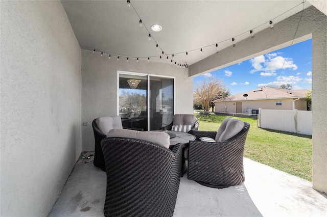 view of patio with an outdoor living space and fence