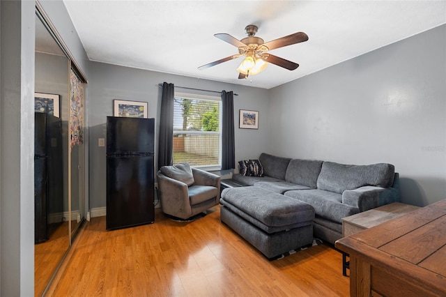 living area featuring a ceiling fan and light wood-style floors